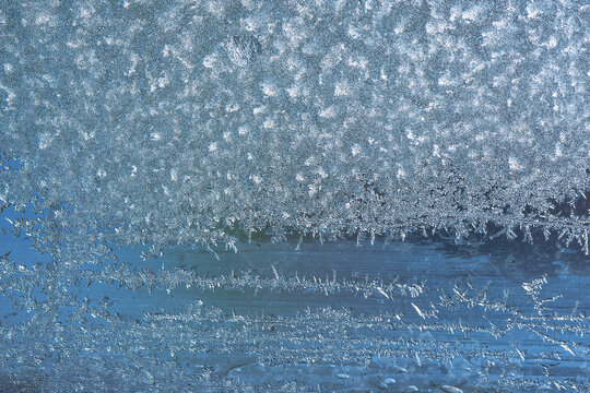 Beautiful natural background or texture of frozen transparent glass on the window in winter, strong cold concept, horizontal image, copy space for your design or text © Aleksandr