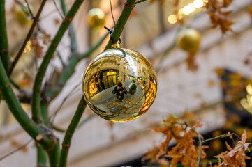 Golden Christmas ball hanging on a twig