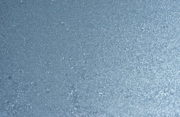 Winter background on a transparent glass of a window with a frozen texture. Abstract texture...