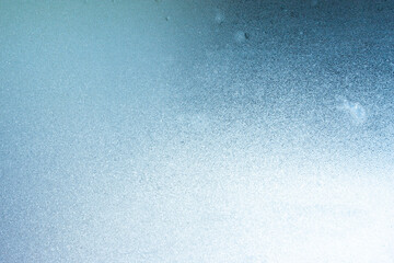 Completely frozen window on transparent glass. Clean background. Extreme low temperatures in winter. Water vapor condenses on cold window glass and freezes