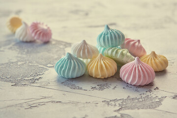 Pastel colored meringue on a beautiful textural background