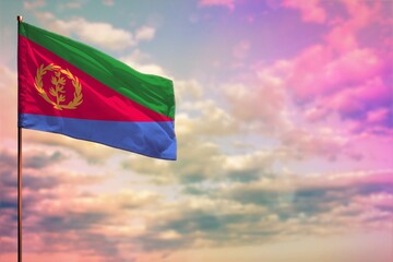 Fluttering Eritrea flag mockup with the space for your content on colorful cloudy sky background.