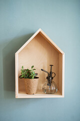 Wooden house shelf with decorations on the wall, natural decor concept.