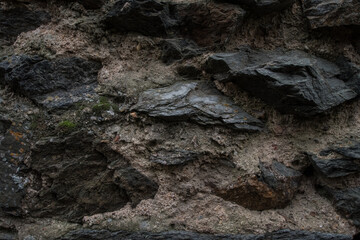 surface of the cave rock wall. gray stone texture background.
