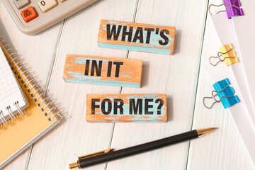 WHAT'S IN IT FOR ME - words written on wooden blocks