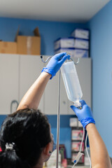Nurse placing physiological saline solution