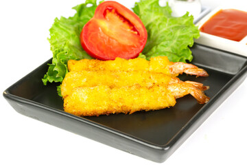 breaded shrimp on black plate isolated on white background