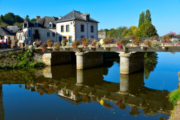 Fototapeta na wymiar River Oust, part of canal Nantes at Brest, and flowered bridge at Josselin, a commune in the Morbihan department in Brittany in north-western France