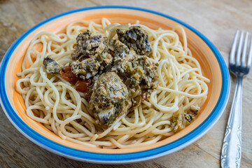 spaghetti with sardine meatballs  and olive