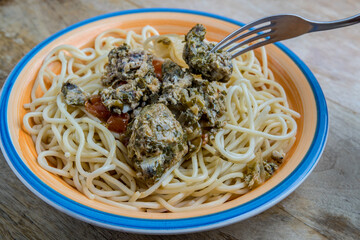 spaghetti with sardine meatballs  and olive