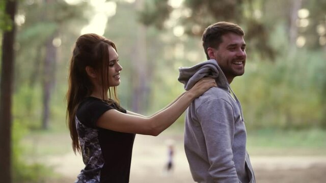 Young woman doing massage to his&nbsp;boyfriend outdoor