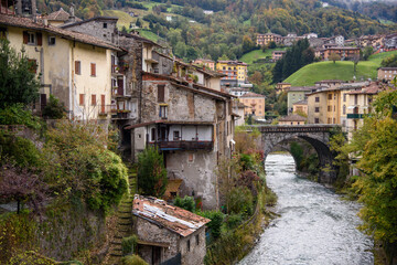 Fototapeta na wymiar Old houses in San Giovanni Bianco, Bergamo, Italy. Ancient village of Italy. View of the Enna stream.