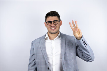 Business young man wearing a casual shirt over white background smiling confident and happy showing number three with fingers