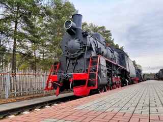 old steam locomotive of black and red color.
