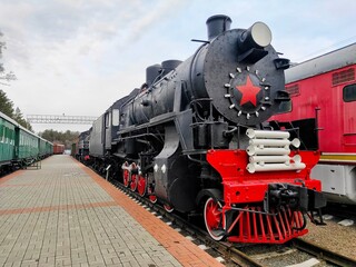 Fototapeta na wymiar old steam locomotive of black and red color.