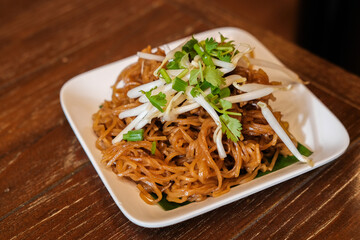 Pad Thai on white dish in Thai restaurant
