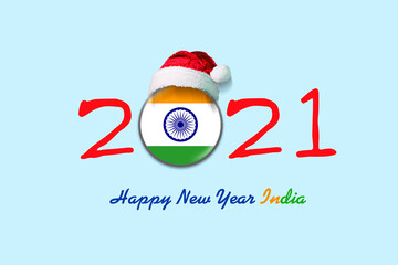 2021. Happy New Year India. Flag of India in a round badge, and in a Santa hat. Isolated on a light blue background. Design element.