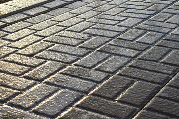 Pavement tiled during icy conditions.