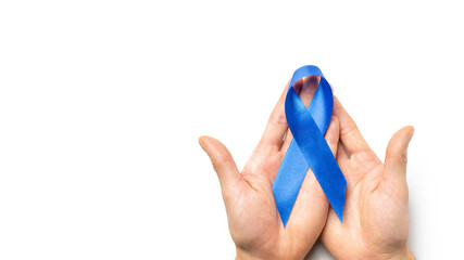 Blue prostate ribbon. Awareness prostate cancer of men health in November. Blue ribbon in hands isolated on white background. November and International Mens Day.