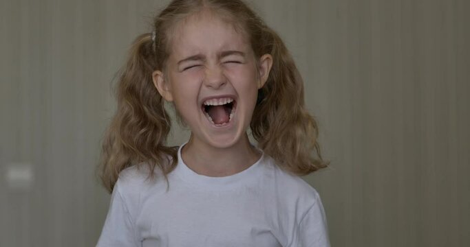 Child Shouting Loud. Portrait of Shocked, Angry and Emotional Little Girl. Young Angry Girl Yelling Screaming Slow Motion. Upset Child Scream Loudly. Adhd Attention Deficit Hyperactivity Disorder.