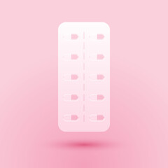 Paper cut Pills in blister pack icon isolated on pink background. Medical drug package for tablet: vitamin, antibiotic, aspirin. Paper art style. Vector.