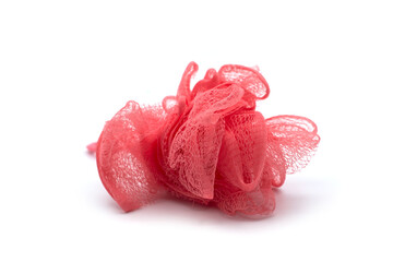 Closeup of pink bath sponge in shaped flower on white background