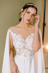 Young brunette woman with blue eyes in white wedding dress