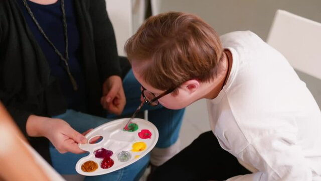 The boy has problems with his eyesight, wears glasses. The benefits of color therapy for people with special needs, to assist children with autism spectrum disorders and Down Syndrome. 
