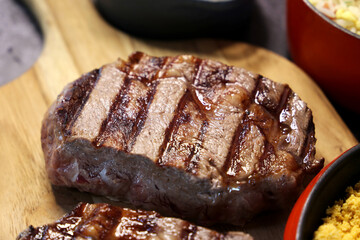 Rib Eye steak grilled in barbecue grill. With excellent accompaniment to meats.