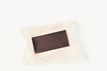 Whole bar of organic dark chocolate with paper wrap