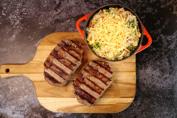 Rib Eye steak grilled in barbecue grill. With excellent accompaniment to meats.