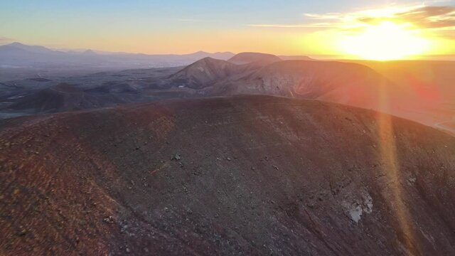 sunset view of a drone moving over the volcanic mountain