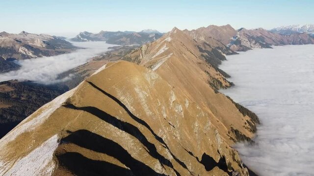 Amazing view over the lush green brienzergrat surrounded by a sea of fog in sunny swiss autumn