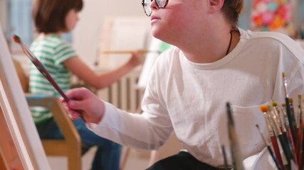 Inclusive education programs provide educational services for all students including those with special needs. An organized art classroom given students with Down syndrome opportunities for success.