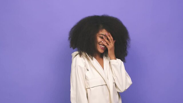 Young african american curly woman confused, feels doubtful and unsure
