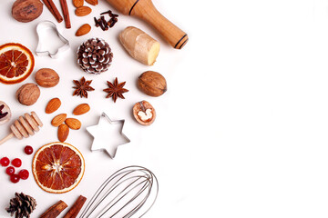 Ingredients for baking gingerbread cookies. Nuts, metal molds, spices and cinnamon. Empty space. Flat lay style