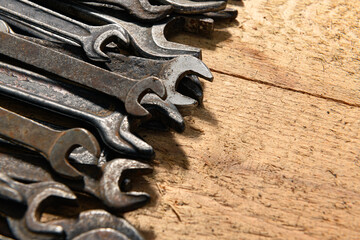 old vintage hand tools - set of wrenches on a wooden background with blank space for text