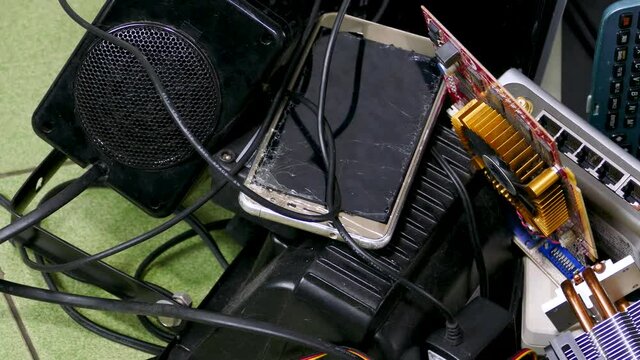 Pile of electronic e-waste products, slide to foreground blur, no visible logos