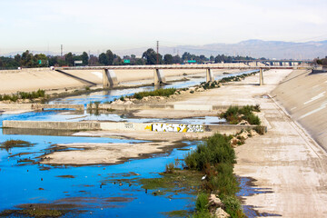 Fototapeta na wymiar Los Angeles River Flowing Through Long Beach CA