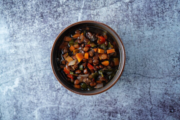 Green Lentil carrots red pepper vegan soup in a bowl