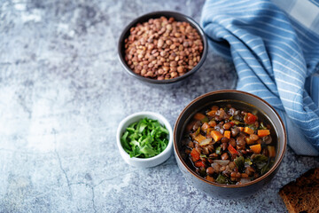 Green Lentil carrots red pepper vegan soup in a bowl