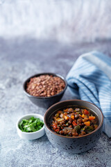 Green Lentil carrots red pepper vegan soup in a bowl