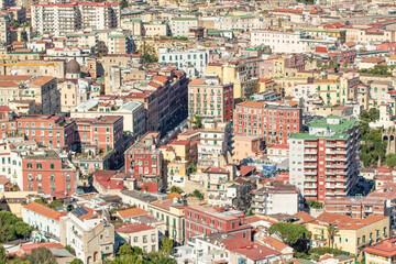 Fototapeta na wymiar Naples, Italy - heavily bombed during World War II, Naples has seen a savage urbanization in the 60s. Here in particular the wild and colorful skyline 