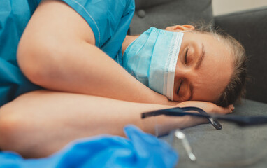 Obraz na płótnie Canvas Tired medical worker after a shift. Burnout at work.