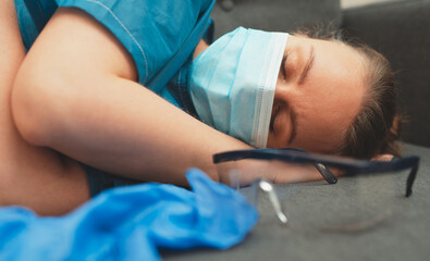 Obraz na płótnie Canvas Tired medical worker after a shift. Burnout at work.