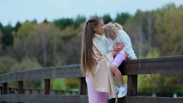 girl with her mom, beautiful mother with daughter spends time together. Happy mother with child enjoying togethe on a wonderful autumn day.