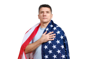 Handsome middle-aged man covered with American flag puts hand on his heart and looking at camera isolated on white background. 