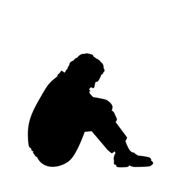 Silhouette of pensive man sitting