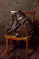 Men's shoes on a wooden stool. Brown boots. Winter shoes. Male style.