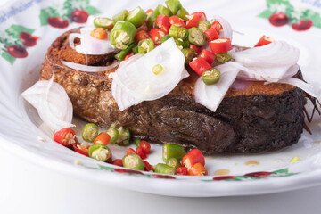 King mackerel made salted, cut into pieces and fried with chili and onion.